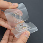 Self-adhesive transparent hook providing a strong hold on a clean wall.
