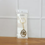 Detailed close-up of premium metal Durga Maa keychain with golden finish