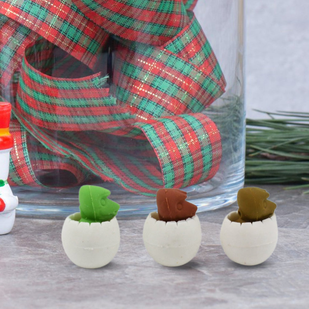 Various colorful dinosaur puzzle erasers arranged on a clean white background.