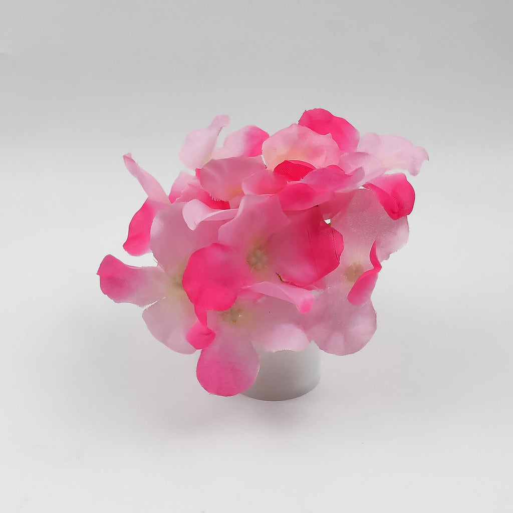 Elegant LED mood light in a glass vase with silk flowers, offering a gentle glow.