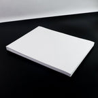 White A4 self-adhesive label sheets stacked neatly for printing