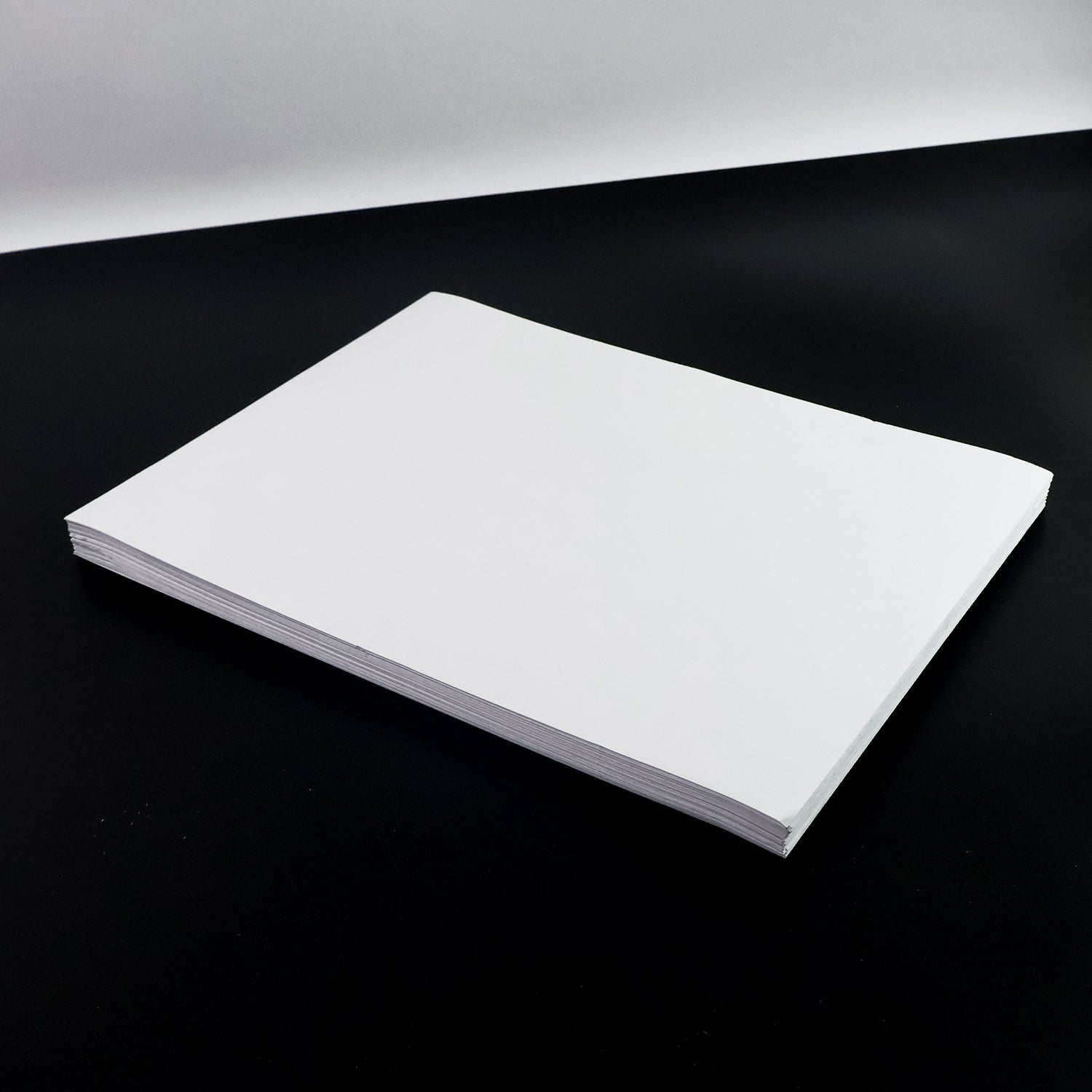 White A4 self-adhesive label sheets stacked neatly for printing