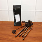 Metal wind chime with Om symbol displayed on white background