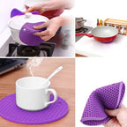 A set of four vibrant silicone hot pot mats in red, yellow, green, and blue.