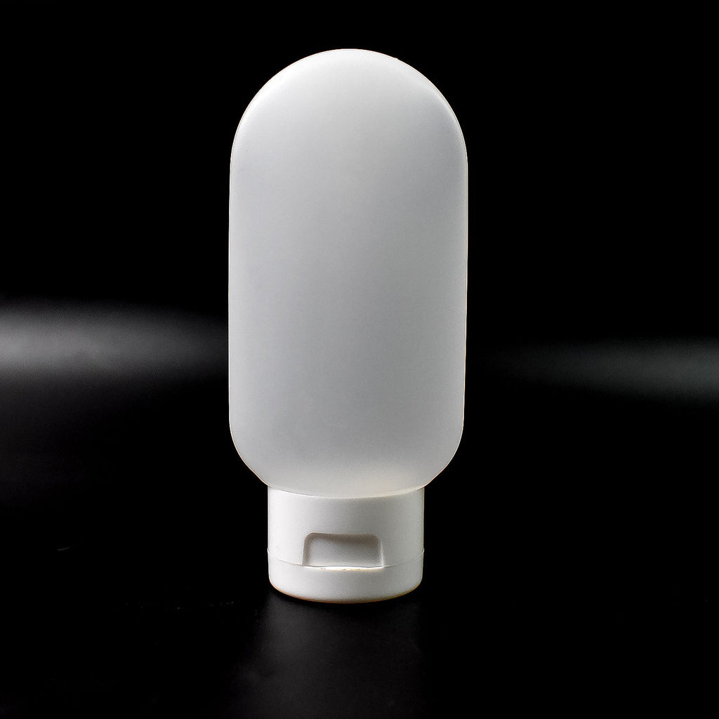 A single 60ml reusable plastic travel bottle in a vibrant mixed color, ready for toiletries.