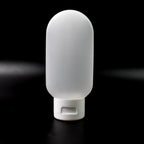 A single 60ml reusable plastic travel bottle in a vibrant mixed color, ready for toiletries.