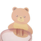 Teddy bear self-adhesive holder keeping toothbrushes and toothpaste neatly stored.