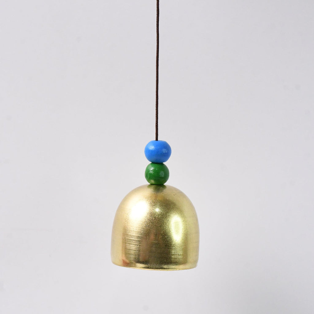 Close-up of metallic outdoor dragonfly wind chime with vibrant colors
