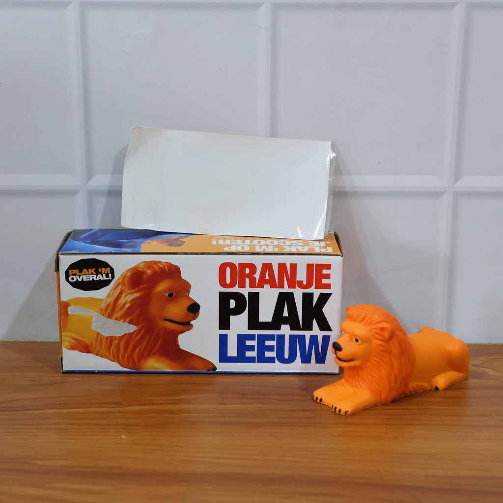 Detailed view of lion dashboard toy with adhesive mount base