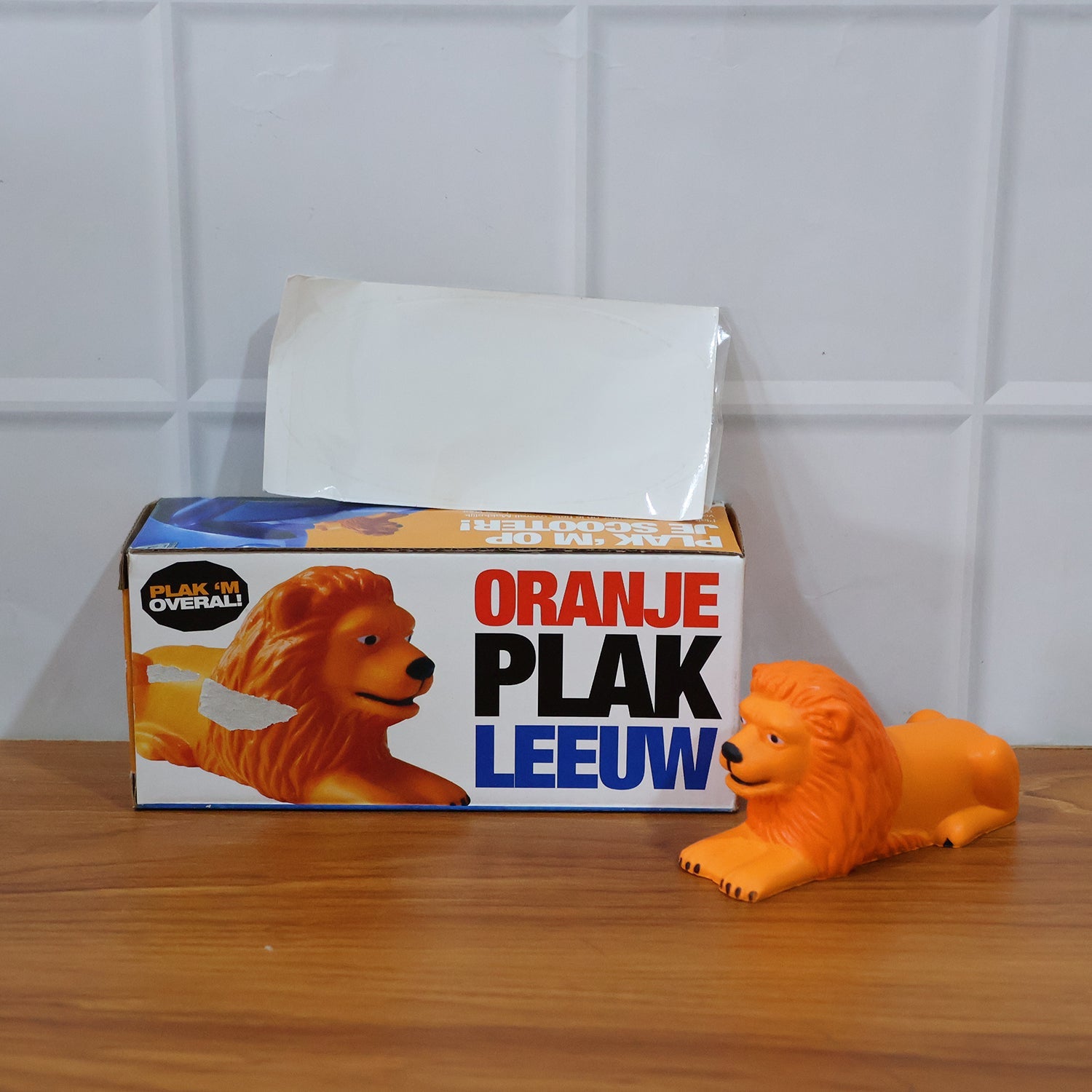 Detailed view of lion dashboard toy with adhesive mount base
