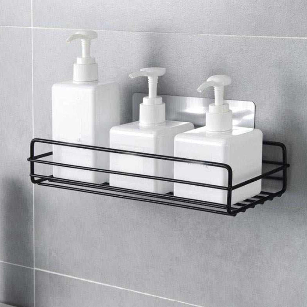 Stainless steel wall mount bathroom shelf holding toiletries.