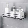 Stainless steel wall mount bathroom shelf holding toiletries.
