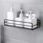 Stainless steel wall mount bathroom shelf holding toiletries.