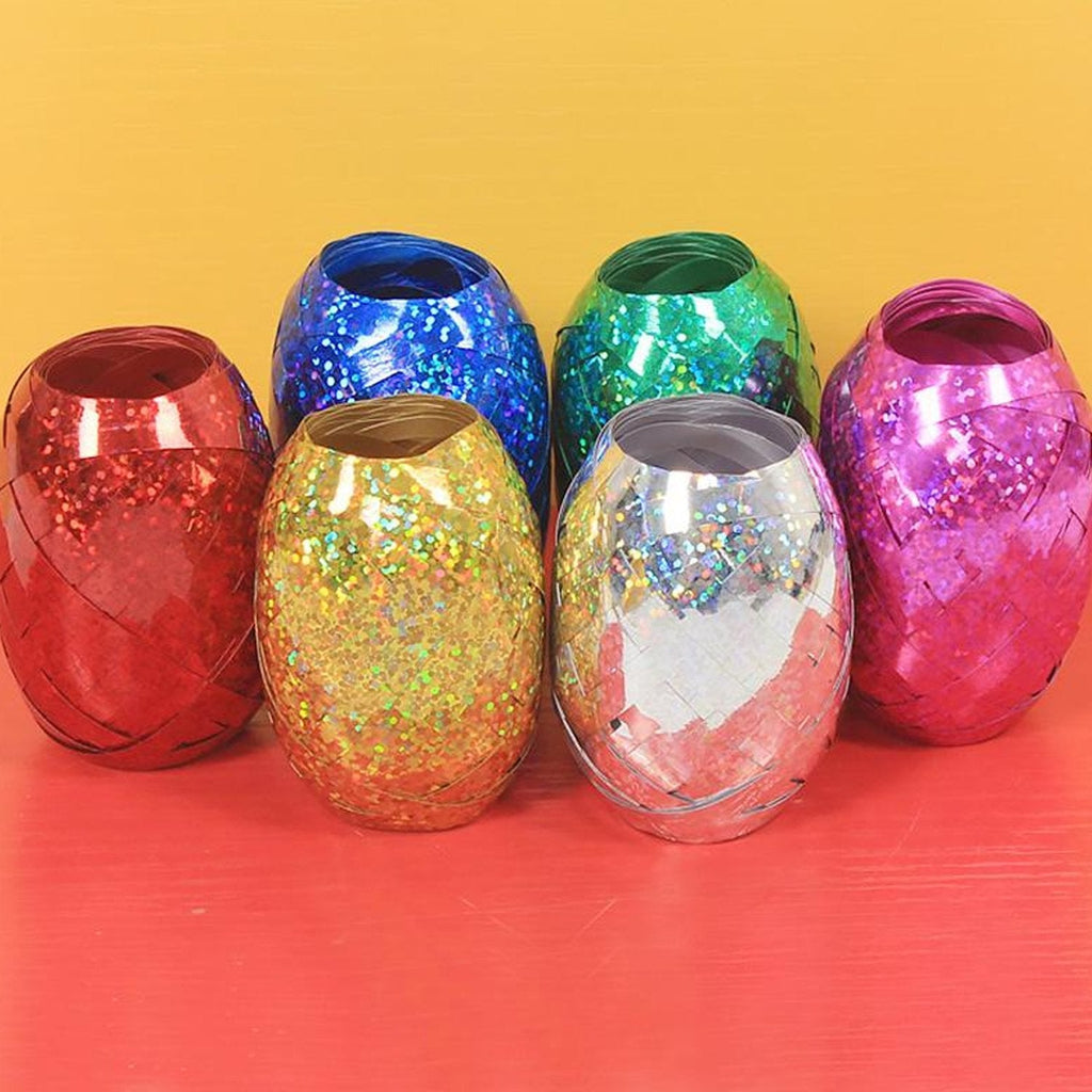 Multicolor curling ribbon rolls displayed for festive party decorations.