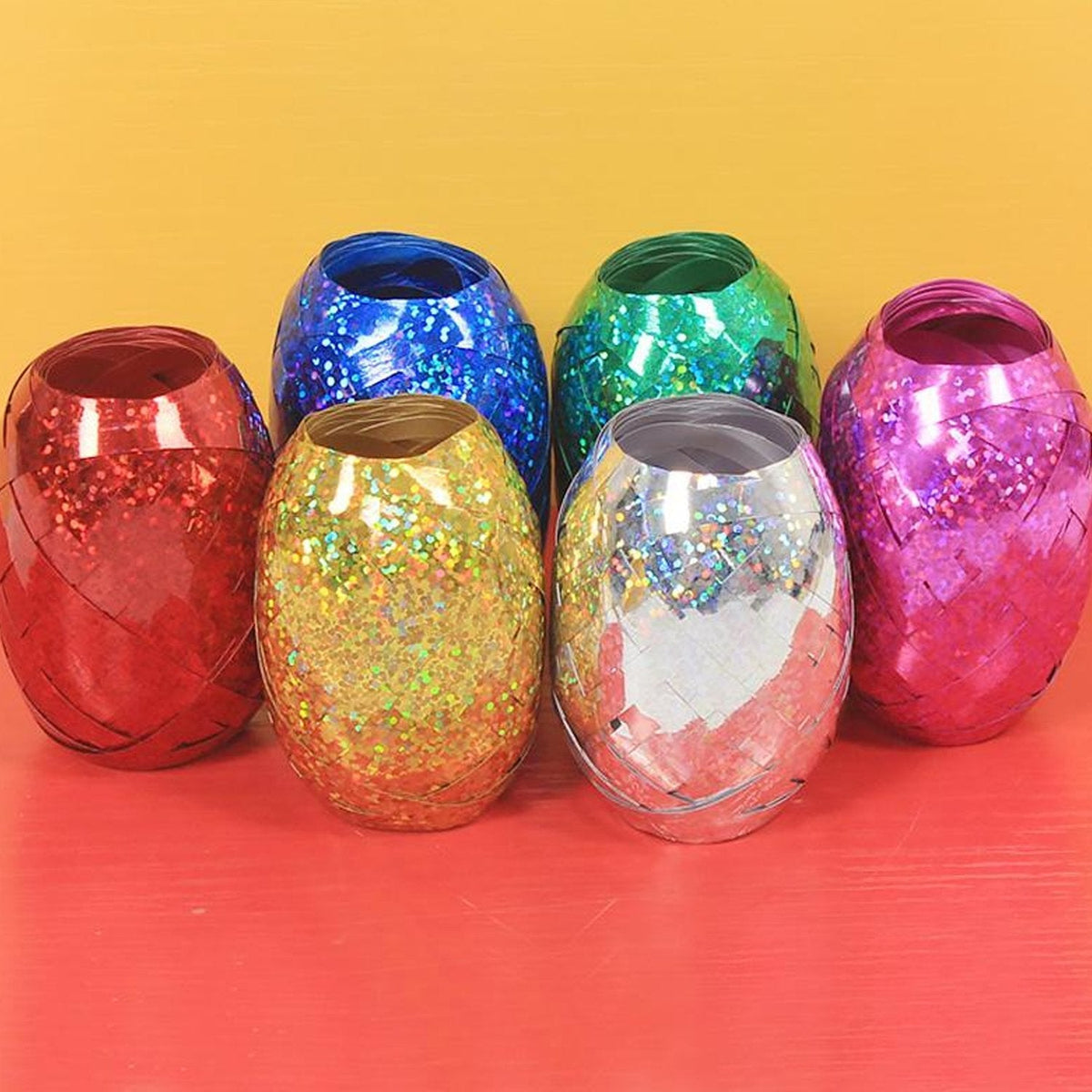Multicolor curling ribbon rolls displayed for festive party decorations.
