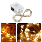 Close-up of battery powered LED fairy lights with copper wire glowing warmly