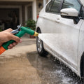 Main view of the green and black water spray gun with an ergonomic lever handle.