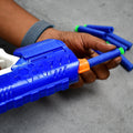 Kids playing with an Aditi foam bullet gun and target.