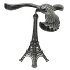 A hand demonstrating the Balancing Eagle Toy's stability by placing it on a fingertip, separate from its stand.