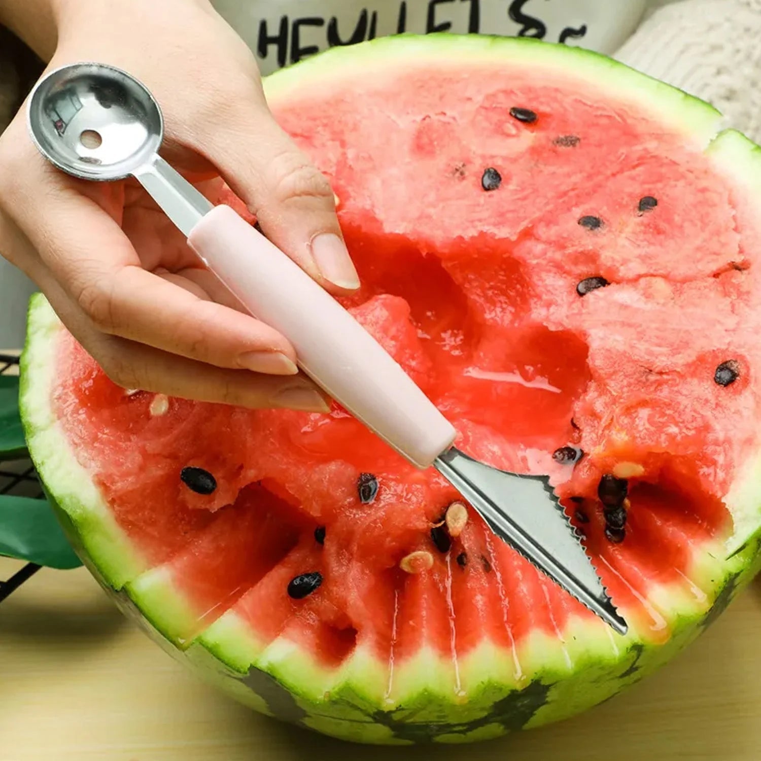 Person straining ingredients using fine mesh strainer from the 5-in-1 set
