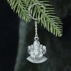 Close-up showing detailed Lord Ganesha sitting design on metal keychain