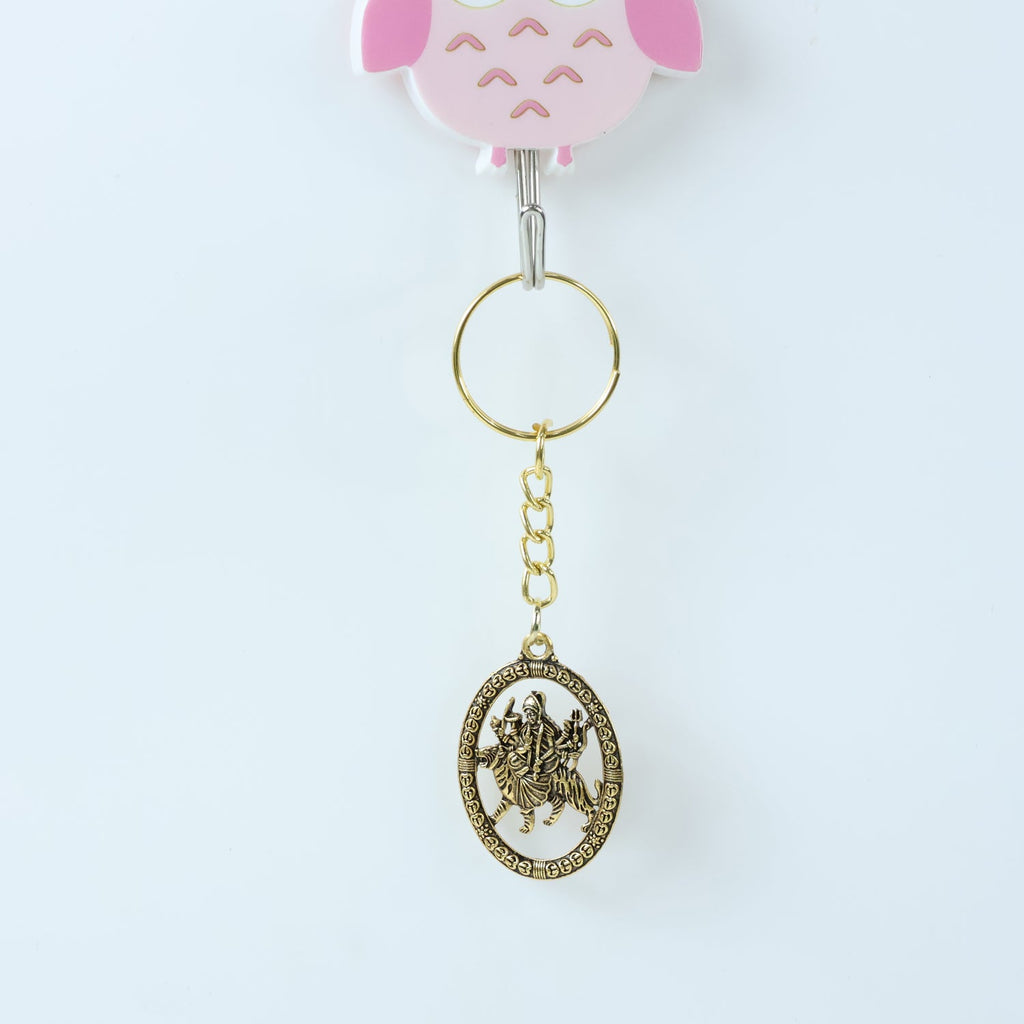 Angled view of Maa Durga Oval Frame Keychain showcasing metallic golden finish