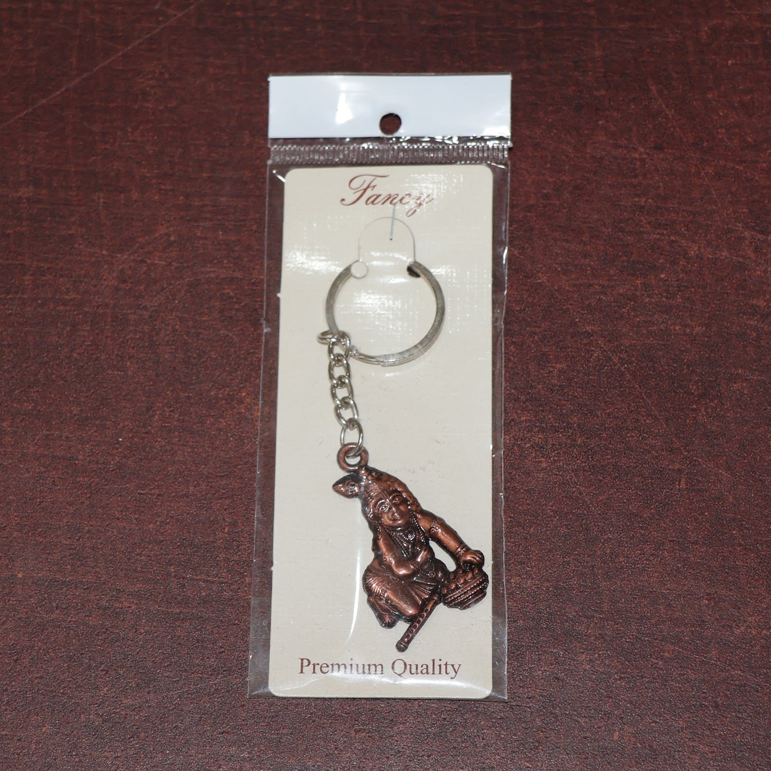 Side view of Bal Krishna metal keychain with sturdy chain and ring