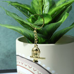 Packaged golden Shivling metal keychain ready for gifting or retail