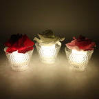 Warm yellow glow from rose shaped flameless LED candle at home décor setting