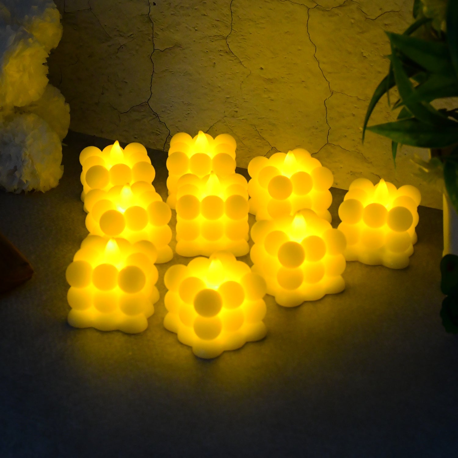 Close-up of decorative LED bubble candles emitting warm white glow