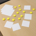 Set of 10 white round fridge magnets on a metal surface, holding notes securely.