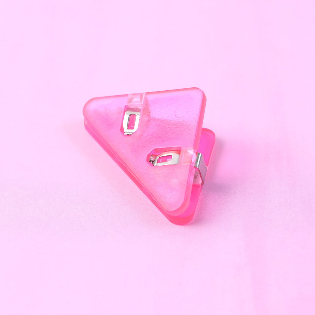 Small triangle paper clip used as corner clip on document