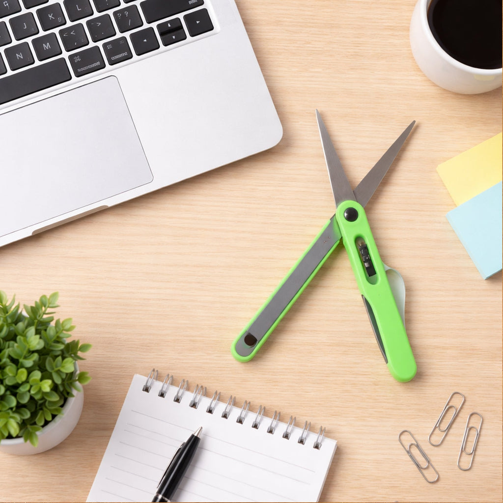 Close-up view of the sharp blades on the portable pen-style scissors.