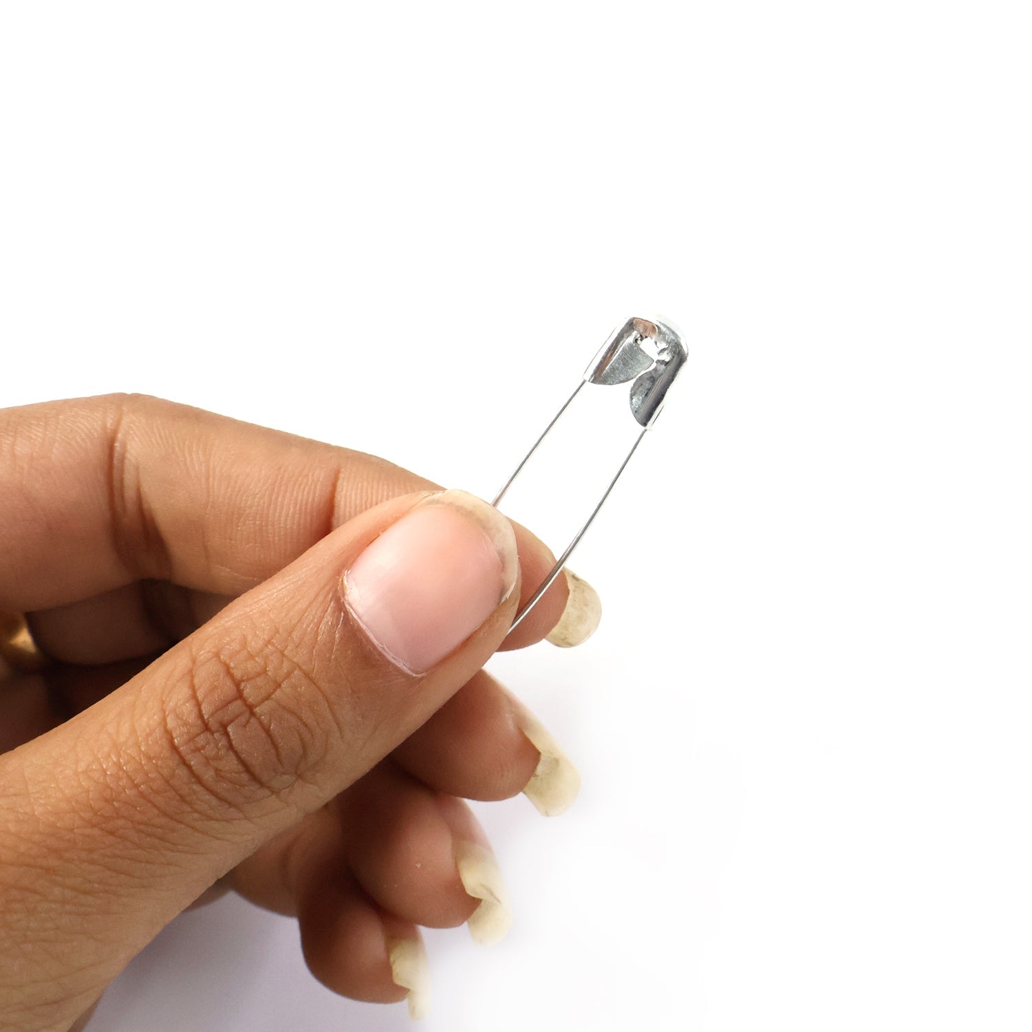 Set of metal safety pins arranged for clothing repair and stitching