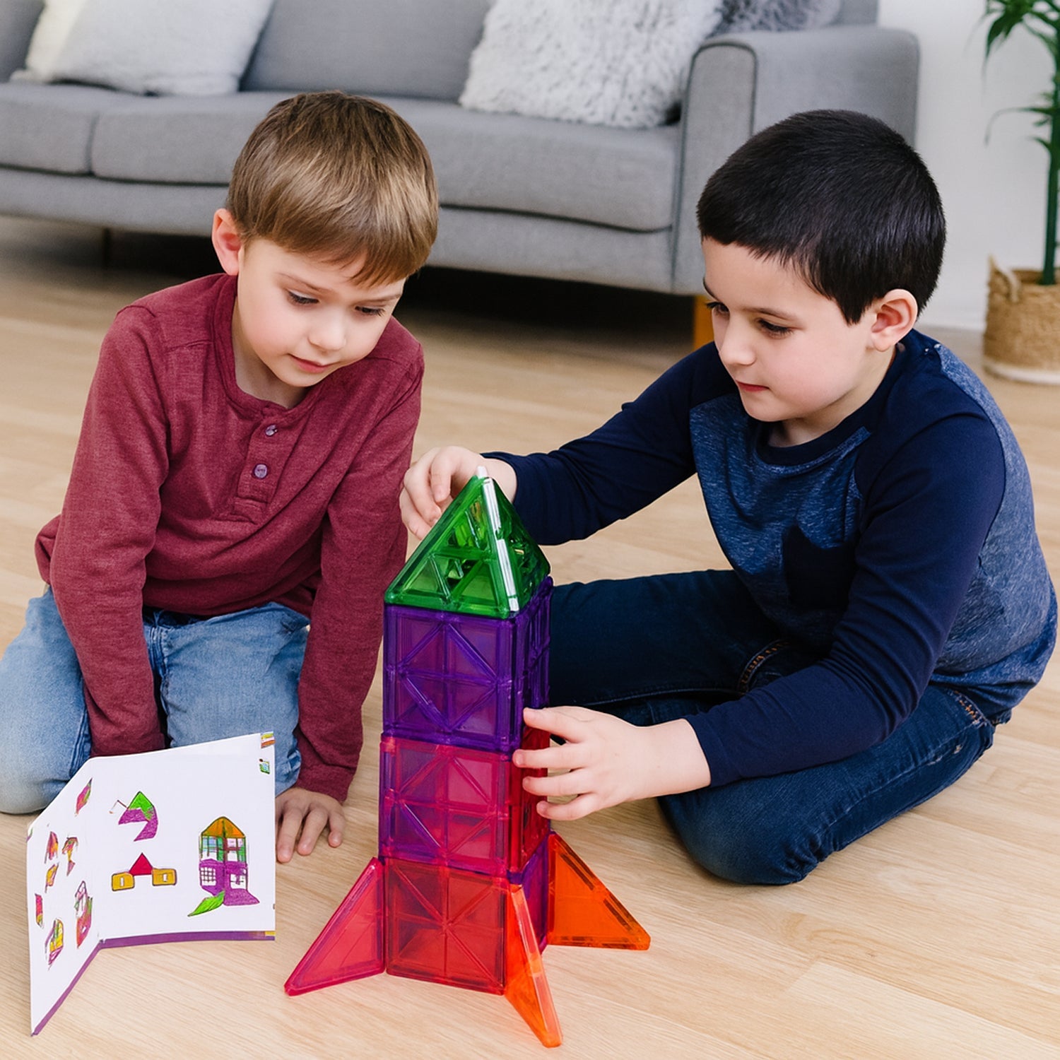 Children playing together using 26-piece magnetic building tiles