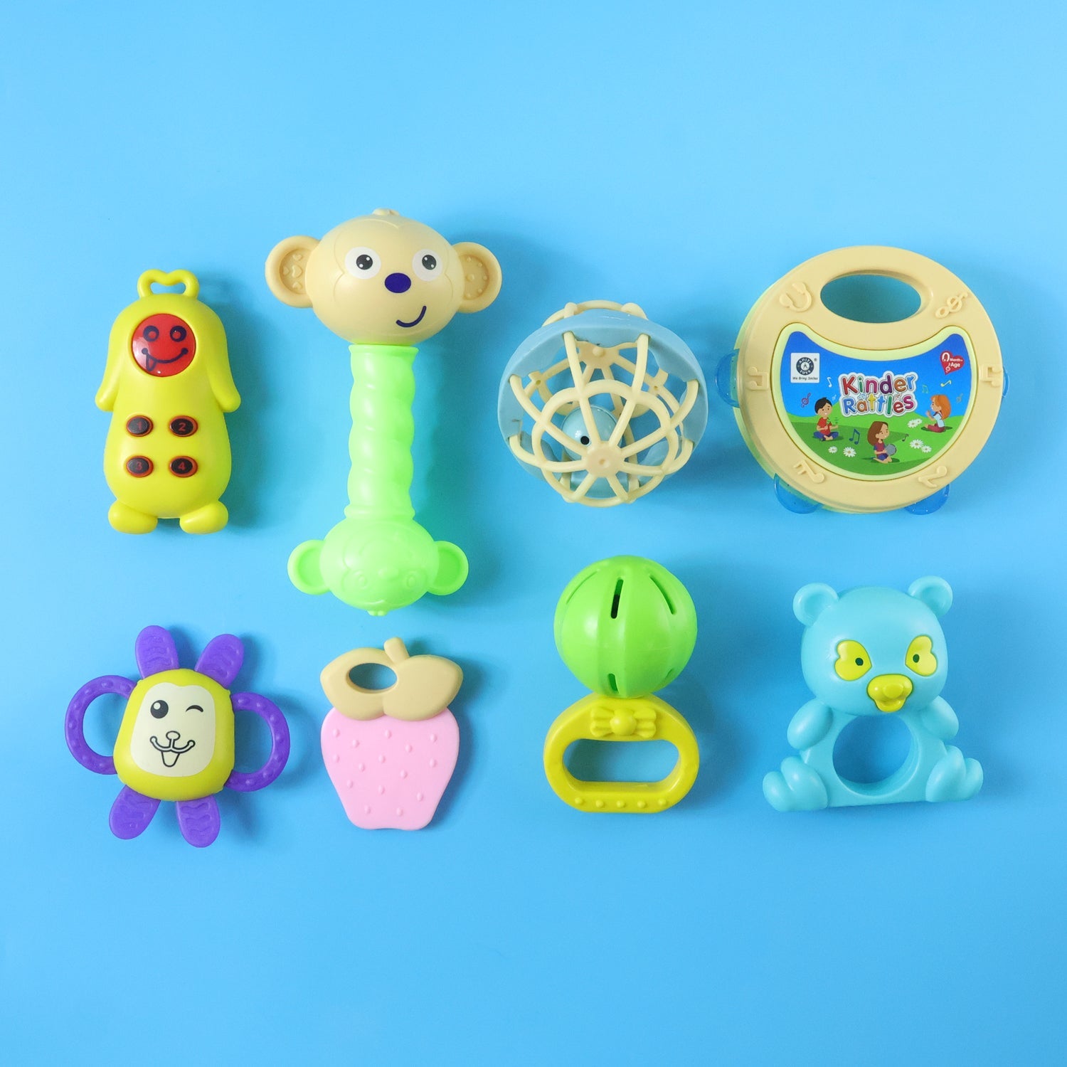 Collection of diverse Aditi Baby Rattles Set pieces in different shapes and colours.