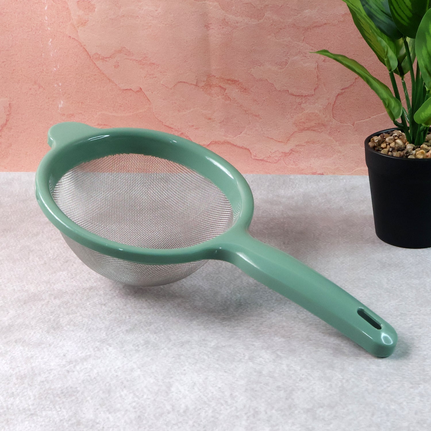 Fine mesh kitchen strainer filtering tea leaves for clear tea preparation