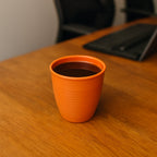 Stacked plastic small drinking glasses for space-saving storage