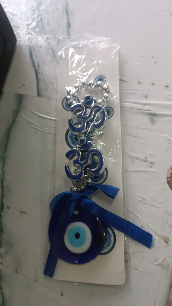 Double OM evil eye hanging displayed indoors enhancing vastu energy