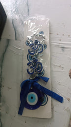 Double OM evil eye hanging displayed indoors enhancing vastu energy