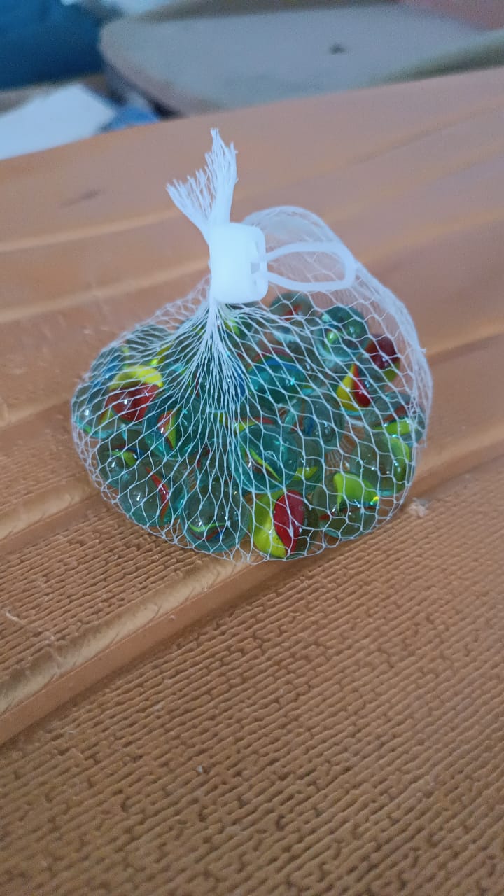 Detailed close-up of glass marbles with vibrant swirl patterns for play and crafts