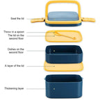 Green lunch box with double layers and a sturdy carrying handle.