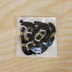 Close-up of handmade black thread rakhi with pearl beads