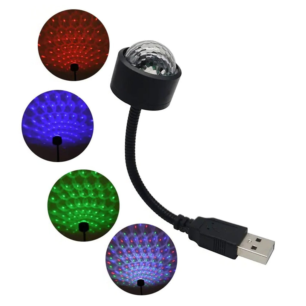 USB star projector casting red light patterns on a car ceiling.