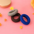 Tyre shape multicolour hair bands in a pack of three, displayed for women.