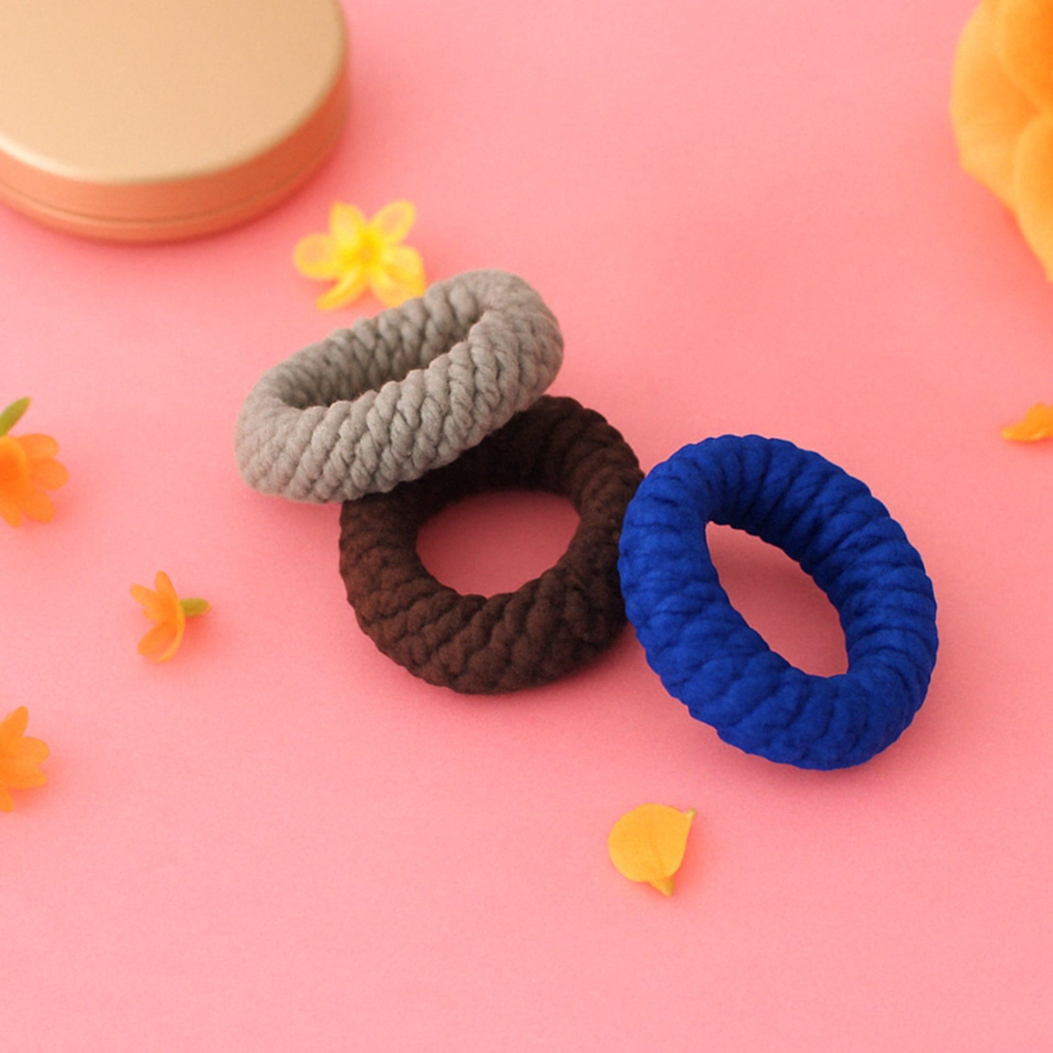 Tyre shape multicolour hair bands in a pack of three, displayed for women.