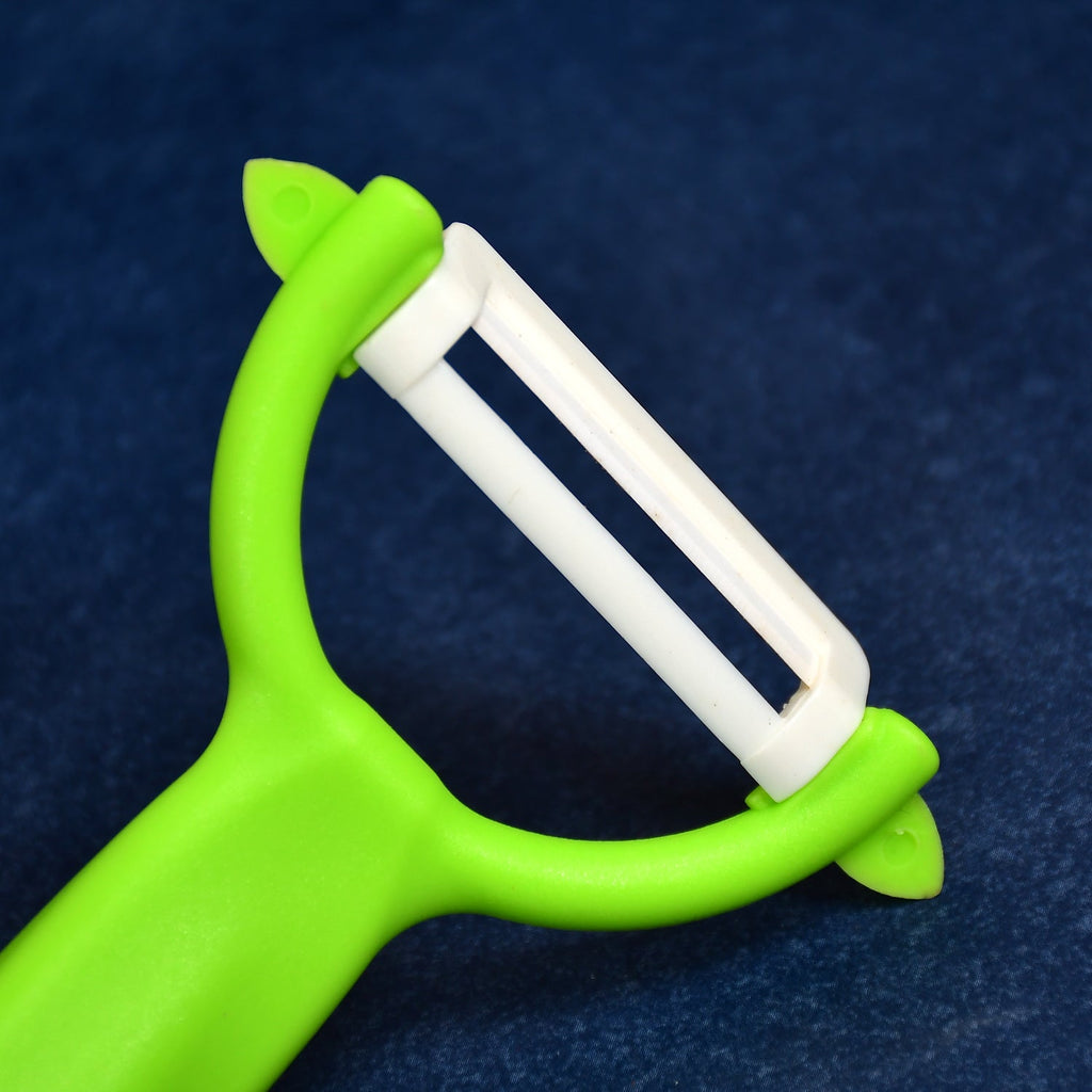 The complete Ceramic Knife Set, featuring a utility knife and a peeler, on a kitchen counter.