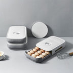 A clear plastic egg storage box with a drawer style, holding eggs inside a refrigerator.