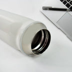 The Kids Insulated Water Bottle next to school supplies, ready for daily use.