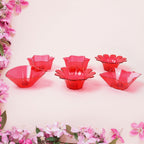 Variety of colorful plastic diyas from the 12-piece set, perfect for any celebration.